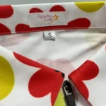 Close-up of a colorful floral shirt collar with a "Sparks Coll" label and size S tag.